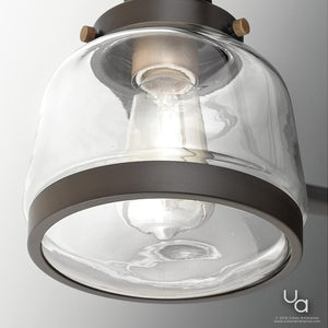 Close-up of the Urban Ambiance UHP2531 Luxe Industrial Chandelier from the Nottingham Collection, featuring a clear glass shade and an Olde Bronze finish, ceiling-mounted and illuminated to cast light downward.