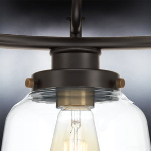 Close-up of the Urban Ambiance UHP2533 Luxe Industrial Chandelier from the Nottingham Collection, featuring an Olde Bronze finish and a clear glass shade that reveals a visible filament bulb inside, set against a dark background.