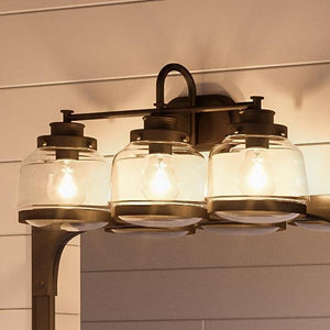An UHP2539 Industrial Chic Bathroom Vanity Light with three beautiful glass jars.