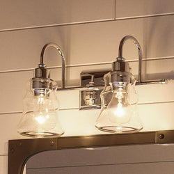 Two unique UHP2552 Vintage Bathroom Vanity Lights, 9.25"H x 15.375"W, with a Polished Chrome Finish from the Columbus Collection by Urban Ambiance hanging above a