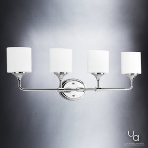 The Urban Ambiance UHP2572 Contemporary Bathroom Vanity Light from the Coventry Collection showcases four white cylindrical etched opal glass shades arranged evenly along a horizontal bar in a sleek polished chrome finish, measuring 11.125″ high by 33.25″ wide, for elegantly diffused illumination against any gray background.