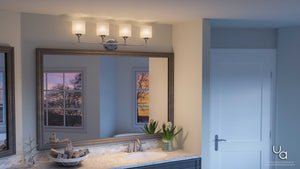 A bathroom with a large mirror, illuminated by the Urban Ambiance UHP2572 Contemporary Bathroom Vanity Light from the Coventry Collection, featuring five etched opal glass fixtures in a polished chrome finish above it; a sink with a plant, white walls, and two windows revealing a sunset view.