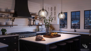 Modern kitchen with dark cabinets, marble island, open shelves, and large windows framing a city view at dusk. Bread and fruit rest on the island counter beneath Urban Ambiance’s Birmingham Collection UHP2580 Vintage Pendant lights in a charcoal finish (14″ H x 11-3/4″ W).