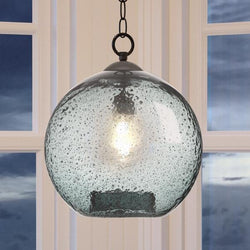 An UHP2581 Vintage Pendant lighting fixture from the Birmingham Collection by Urban Ambiance hanging in front of a window.
