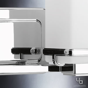 Close-up of the Urban Ambiance UHP2601 Transitional Bathroom Vanity Light from the Modena Collection, showcasing its sleek design and polished chrome finish with reflective surfaces set against a gradient gray background. Urban Ambiance watermark in the lower right corner.