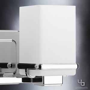 Close-up of the Urban Ambiance UHP2601 Transitional Bathroom Vanity Light from the Modena Collection, showcasing its polished chrome finish and frosted white rectangular shade with subtle etched opal glass accents, set against a dark background.