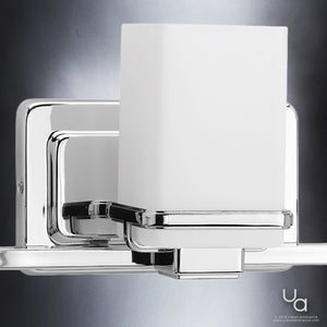 Close-up of the Urban Ambiance UHP2603 Transitional Bathroom Vanity Light from the Modena Collection, featuring a polished chrome finish and a frosted rectangular glass shade, elegantly mounted against a gradient gray background—an ideal choice for sophisticated bathroom lighting.