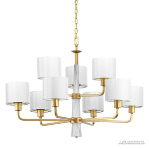 Elevate your space with the Urban Ambiance UHP2630 XL Cosmopolitan Chandelier from the Oxford Collection, featuring a Palladian Gold finish, white central column, and eight white fabric drum shades, elegantly suspended on a gold chain.