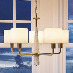 An Urban Ambiance UHP2631 Cosmopolitan Chandelier with four beautiful shades in front of a window