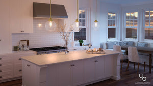 Modern kitchen with white cabinets, marble island, stainless steel stove, and a dining nook by large windows overlooking a scenic evening view, illuminated by Urban Ambiance’s UHP2643 Vintage Pendant from the Glasgow Collection in Native Brass finish.