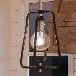 A beautiful Urban Ambiance UHP2661 Industrial Chic Pendant Light, 12.375"H x 12.5"W, with a Polished Chrome Finish from the Spokane Collection hanging over