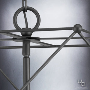 Close-up of the Urban Ambiance UHP2703 Contemporary Chandelier from the Aberdeen Collection, featuring a modern midnight black finish with geometric design elements such as intersecting rods and a circular ring at the top; measures 19″ high by 23.5″ wide.