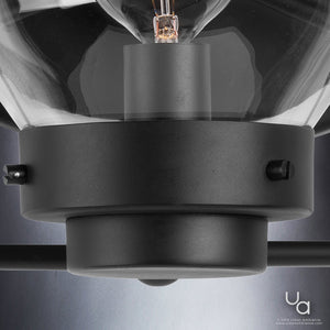 Close-up of the UHP2707 Contemporary Bathroom Vanity Light from Urban Ambiance’s Aberdeen Collection, featuring a sleek midnight black metal finish and a clear glass shade—showcasing the bulb tip and part of the mounting hardware. Urban Ambiance watermark is visible in the bottom right corner.
