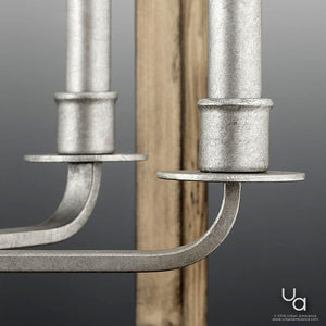 Close-up of the UHP2741 Modern Farmhouse Chandelier from the Brighton Collection by Urban Ambiance, featuring a galvanized steel finish with dual candle sockets. A rustic wood lighting element appears in the background against a gray gradient backdrop. The Urban Ambiance logo is displayed in the bottom right corner.