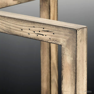 Close-up of two intersecting wooden frames with visible grain and small holes on one piece, capturing the rustic charm of the UHP2741 Modern Farmhouse Chandelier from Urban Ambiance’s Brighton Collection (28-3/4″H x 26″W, Galvanized Steel Finish), set against a neutral background.