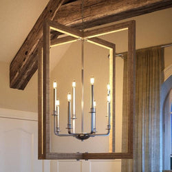 A beautiful, modern farmhouse chandelier from Urban Ambiance hangs in a room with wooden beams.