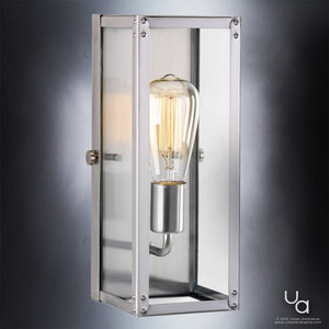 The Urban Ambiance UHP2750 Luxe Industrial Electric Bath / Wall Light from the Messina Collection features a rectangular wall-mounted design with an exposed bulb encased in a metal and glass frame, finished in stainless steel and set against a gradient gray background.