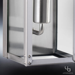 Close-up of the Urban Ambiance UHP2750 Luxe Industrial Electric Bath / Wall Light from the Messina Collection, featuring a sleek stainless steel finish with modern metal and glass construction and visible screw details at the corner—an ideal design accent for contemporary bathrooms.
