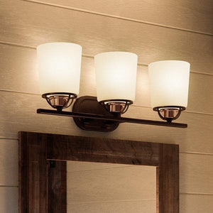 A gorgeous Urban Ambiance bathroom vanity with three UHP2761 Transitional Bath Fixtures and a mirror.