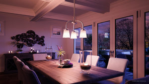 A gorgeous dining room with an Urban Ambiance UHP2763 Transitional Chandelier, 16-1/8