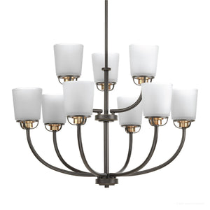 The UHP2768 Transitional Chandelier from the Urban Ambiance Boise Collection features two tiers of black metal arms, each supporting white cylindrical glass shades. Measuring 20-3/8″ x 31-1/4″ with an Olde Bronze finish, this striking fixture brings a contemporary twist to classic Boise lighting designs.