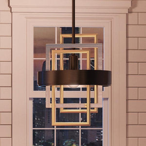 The Urban Ambiance UHP2781 Modern Pendant Light from the Vegas Collection, measuring 14-5/8″ x 12″ with a sophisticated midnight black finish, hangs in front of a window overlooking the city. Set against white-paneled walls, this striking fixture adds modern elegance to the room.
