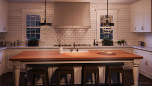 A modern kitchen featuring a spacious wooden island with three stools, white cabinets, a subway tile backsplash, and the UHP2781 Modern Pendant Light from the Vegas Collection by Urban Ambiance in a midnight black finish hanging overhead. A cutting board with bread rests on the island.