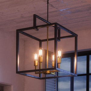 An UHP2805 Modern Farmhouse Farmhouse Chandelier, 25-3/4" x 23-1/4", Charcoal Finish, Cordoba Collection by Urban Ambiance hanging over a window.