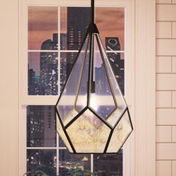A beautiful Mid-Century Modern pendant lamp, 18-1/2" x 12", with Olde Bronze Finish from Urban Ambiance hanging over a window with a city view