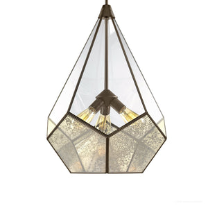 The UHP2851 Mid-Century Modern Chandelier from Urban Ambiance’s Bari Collection features a striking geometric metal frame in an elegant Olde Bronze finish, adorned with clear and antiqued glass panels and exposed bulbs. Measuring 25-7/8″ x 19″, this fixture brings sophisticated style and timeless appeal to any space.
