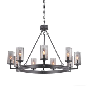 The Urban Ambiance UHP2892 XL Rustic Chandelier from the Livorno Collection features a charcoal finish, eight lights with cylindrical seeded glass shades, and chain suspension for an industrial look. Size: 24-7/8