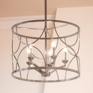 A beautiful Urban Ambiance UHP2913 French Country Chandelier with an antique silver finish hangs in a room from the Breda Collection.