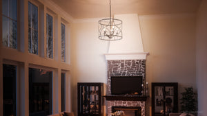 A living room with a beautiful UHP2913 French Country Chandelier lighting fixture and a fireplace.
