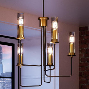 An Urban Ambiance UHP2981 Industrial Chandelier with a gorgeous Charcoal Finish, Pamplona Collection and four candle holders in a room with a large window.