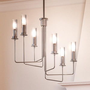 A beautiful Urban Ambiance UHP2982 Industrial Chandelier, 25-1/4" x 28", with a Brushed Nickel Finish from the Pamplona Collection hanging in a room