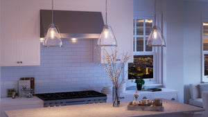 Beautiful pendant lighting fixture in a kitchen with white cabinets and a view of the city, furnished with the UHP2992 Industrial Pendant Light from the Rochdale Collection by Urban Ambiance.