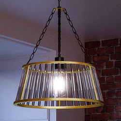 A unique Art Deco pendant lamp, 23" x 20", Midnight Black Finish, Rochdale Collection by Urban Ambiance hanging over a brick wall.