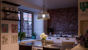 A kitchen with the unique UHP3021 Art Deco Pendant Light and gorgeous table and chairs from the Rochdale Collection exudes luxury.