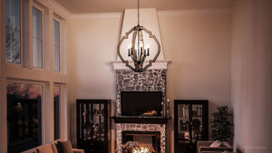 A stunning living room with a UHP3031 Rustic Chandelier from Urban Ambiance and a beautiful fireplace.