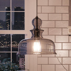 A kitchen with a UHP3041 Modern Farmhouse Farmhouse Pendant Light, 11-1/4" x 12", Charcoal Finish, Dundee Collection by Urban Ambiance over a window.