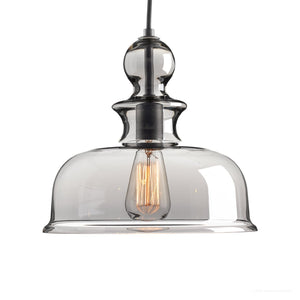 Elevate your space with the Urban Ambiance UHP3041 Modern Farmhouse Pendant Light from the Dundee Collection—a handcrafted 11-1/4″ x 12″ pendant featuring a clear glass shade and exposed filament bulb, gracefully suspended by a black cord and finished in striking charcoal for modern elegance.
