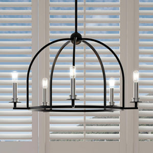 Luxury chandelier with beautiful Midnight Black Finish hanging over a window with shutters.