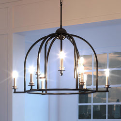 A beautiful Colonial chandelier from the luxury Somerville Collection by Urban Ambiance, featuring a midnight black finish, hanging in a room.