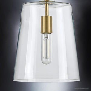 A luxury UHP3070 Colonial Pendant Light from Urban Ambiance, featuring a unique clear glass shade and a brass base.