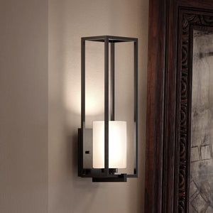 A luxury lighting fixture with a glass shade, the UHP3141 Minimalist Wall Light from the Kennewick Collection by Urban Ambiance features a Midnight Black Finish.