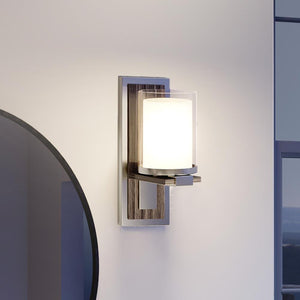 A beautiful Urban Ambiance UHP3160 Contemporary Wall Lights, 13"H x 5"W, Brushed Nickel Finish, Evanston Collection in a bathroom with a mirror.