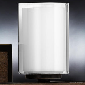 A gorgeous Evanston Collection lamp with a unique Olde Bronze Finish, sitting on top of a wooden table.
