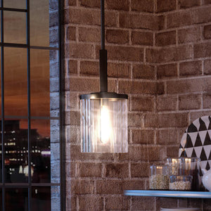 A luxury pendant light illuminating a gorgeous brick wall.