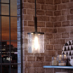 A luxury pendant light illuminating a gorgeous brick wall.