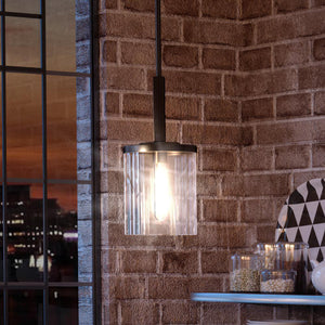 A luxury pendant light illuminating a gorgeous brick wall.